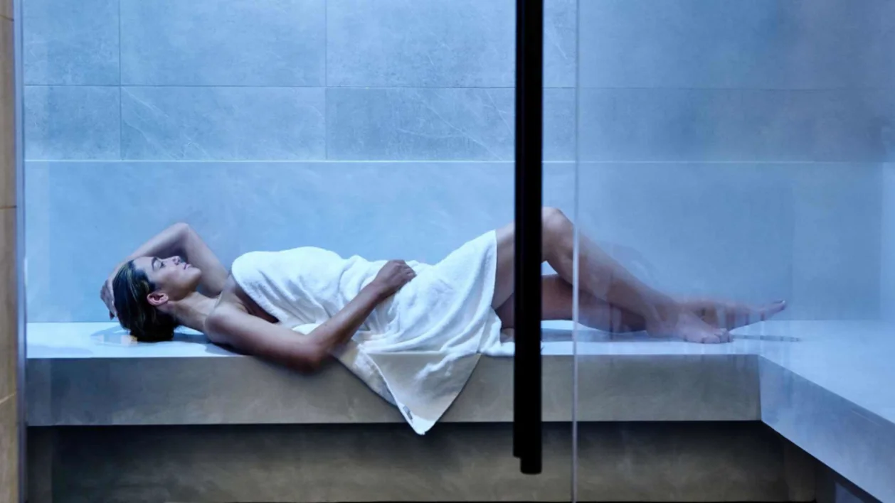 Woman lounging in a steam room at The Thompson Dallas
